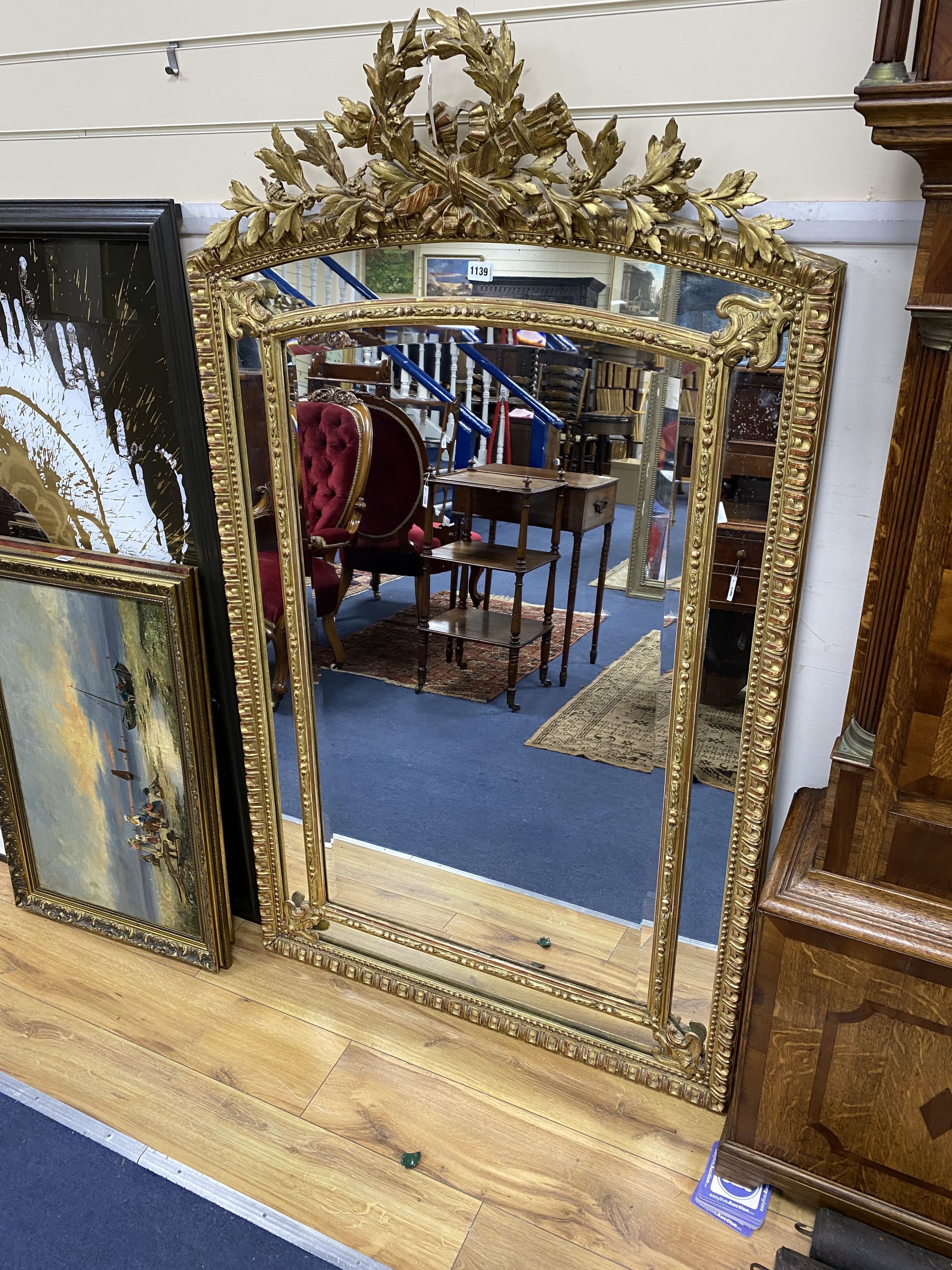 A 19th century giltwood and gesso overmantel mirror with Olympic Torch & Laurel Crown, side cushions with decorated bead detail, width 92cm, height 153cm